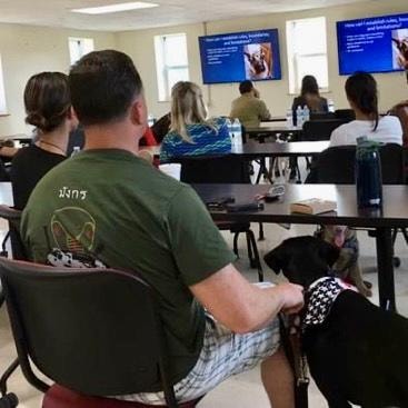 Dog owners attending a training class seminar