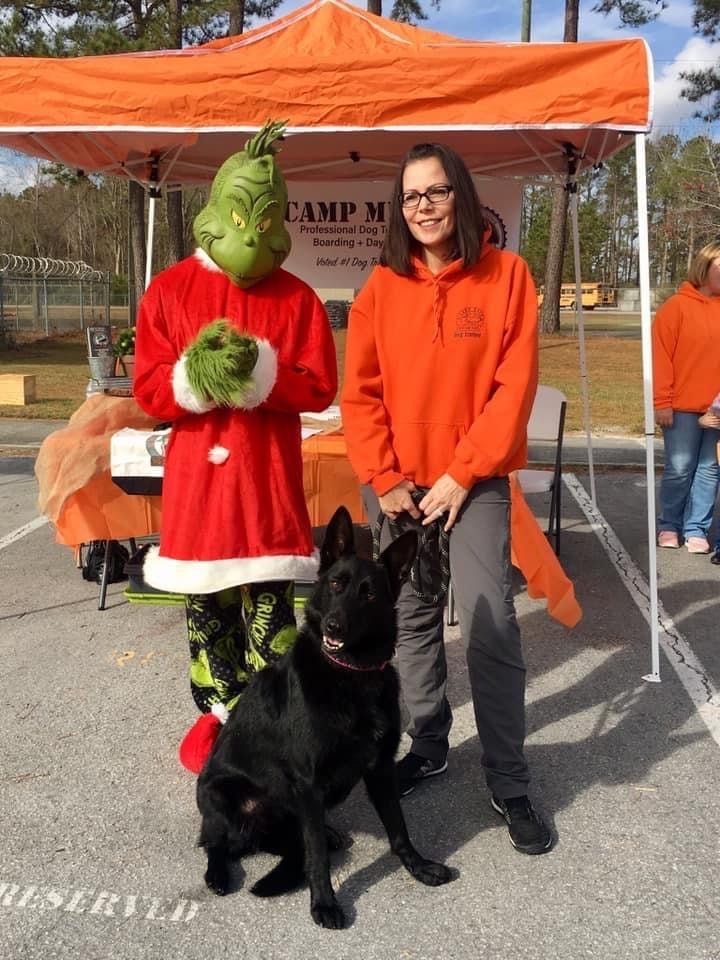 Trainer with dog at Camp Mutt Grinch event