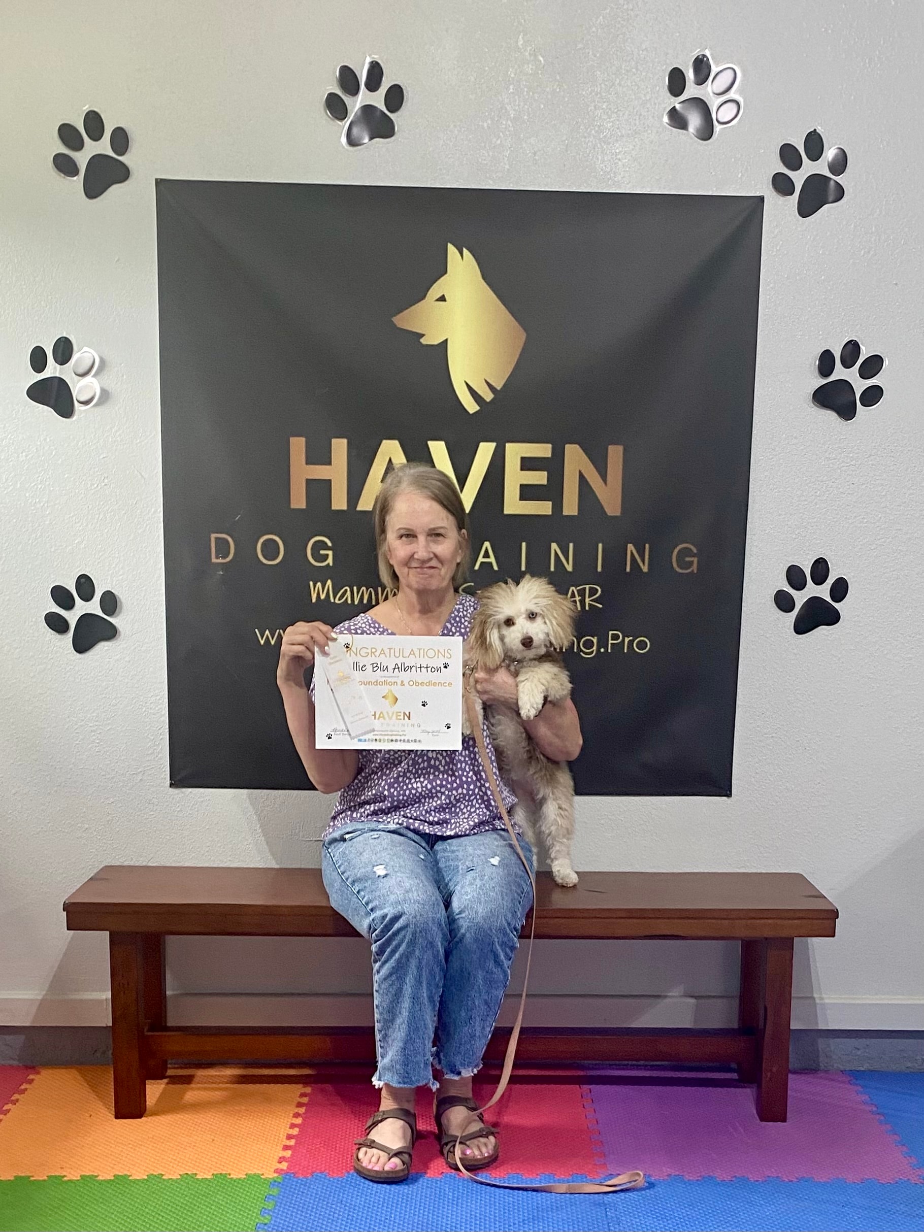Nellie Blu — woman holding Intermediate Obedience certificate at Haven banner