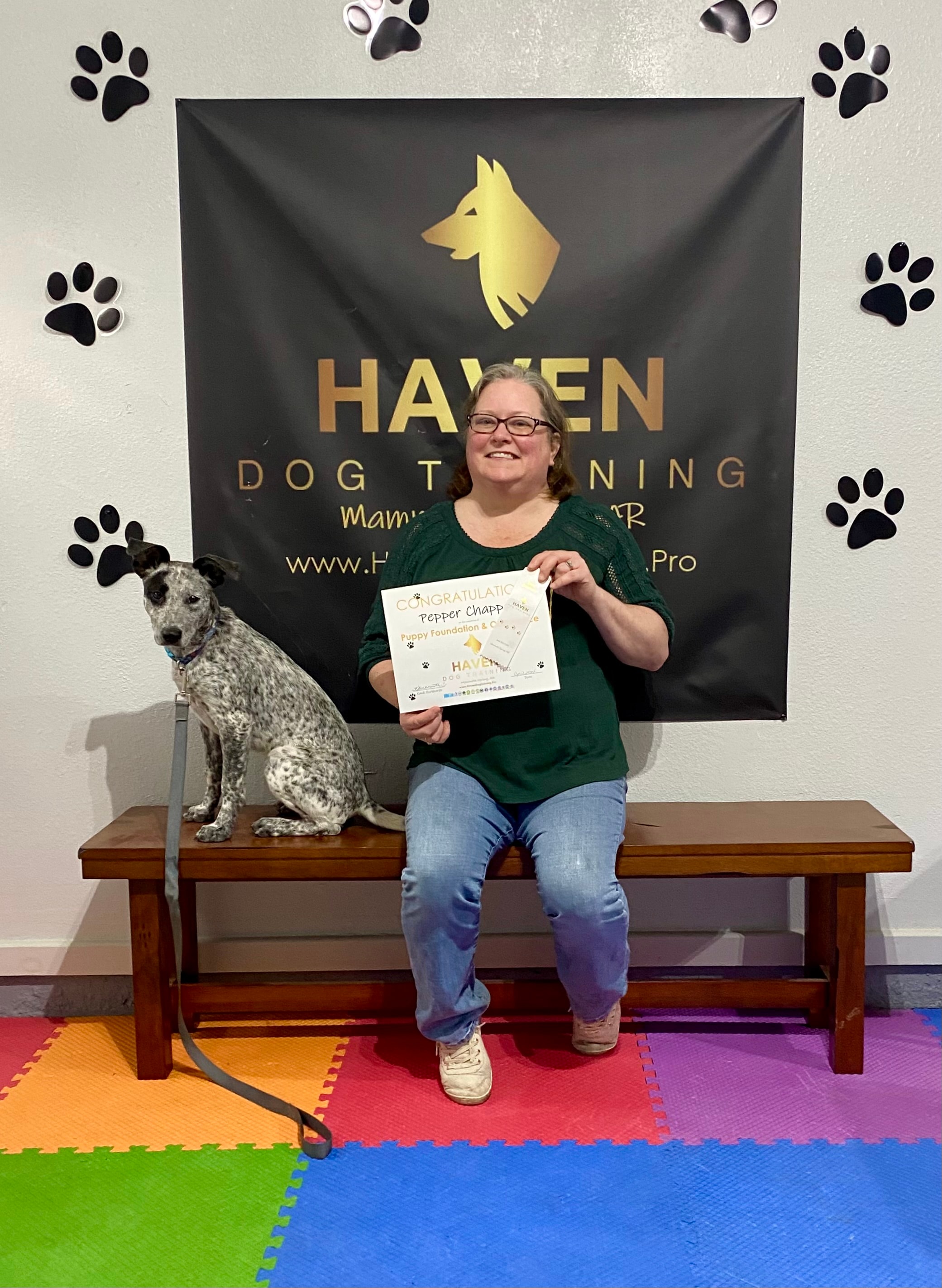 Pepper — owner holding puppy graduation certificate at Haven banner