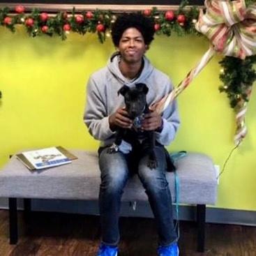 Puppy graduation — man holding young dog in festive holiday setting