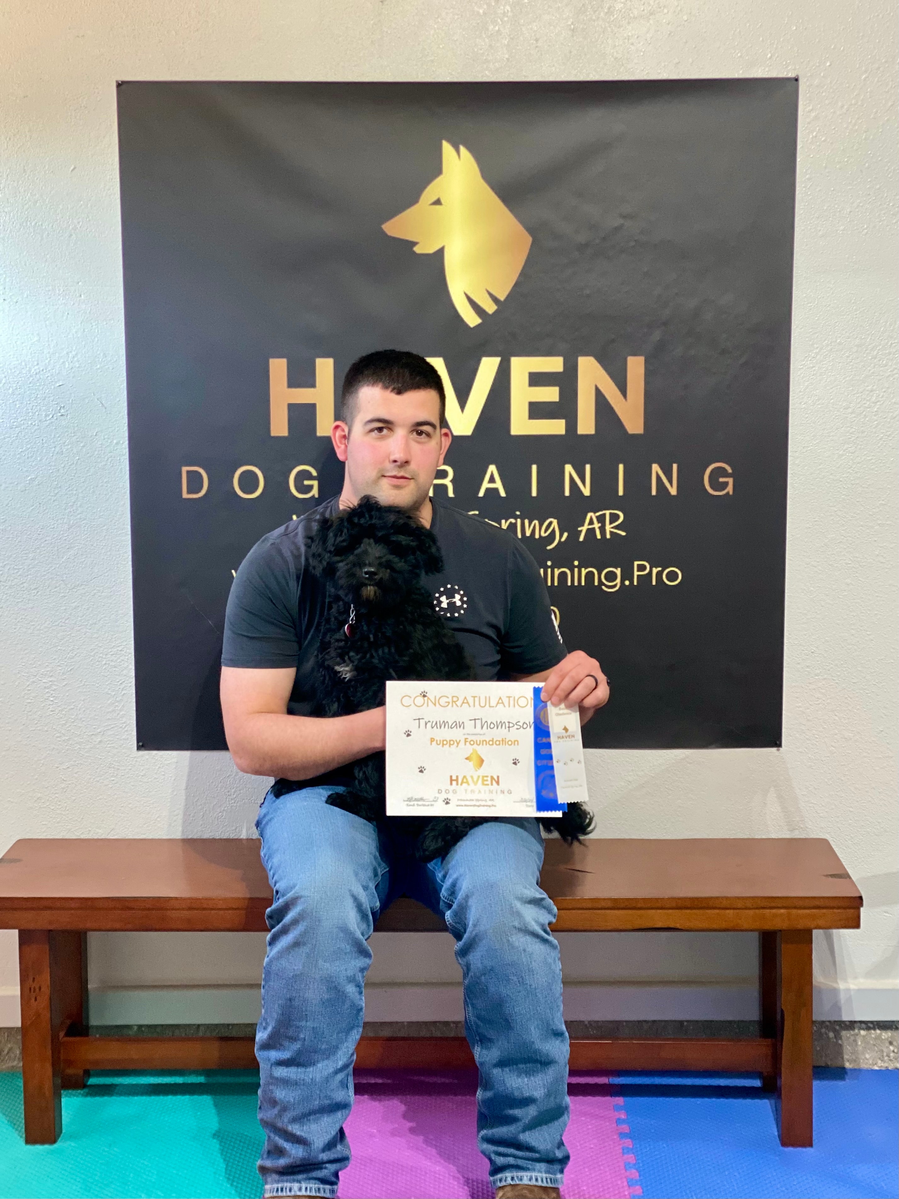 Truman Thompson — graduate with owner holding certificate at Haven banner