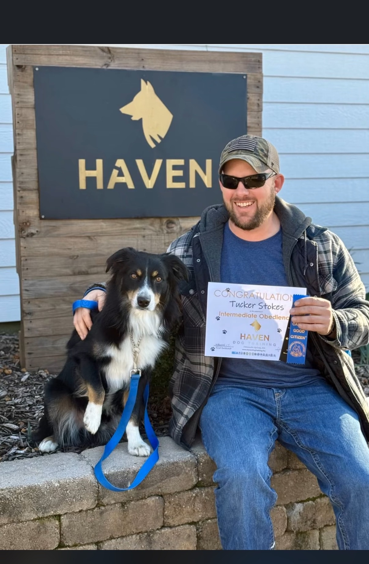 Tucker Stokes — Obedience graduate with owner holding certificate at Haven banner